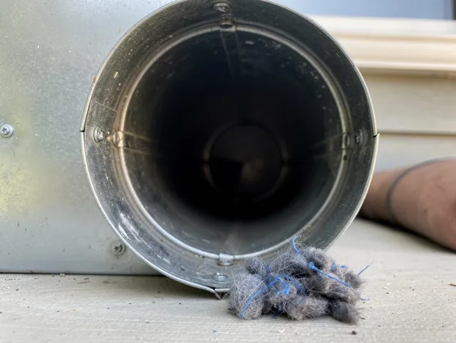 Indian Trail Dryer Vent Cleaning technician using specialized equipment to clear severe dryer vent blockage in Indian Trail